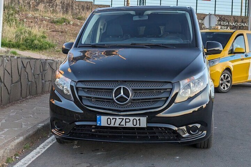 A black Mercedes-Benz SUV parked on a street. 4