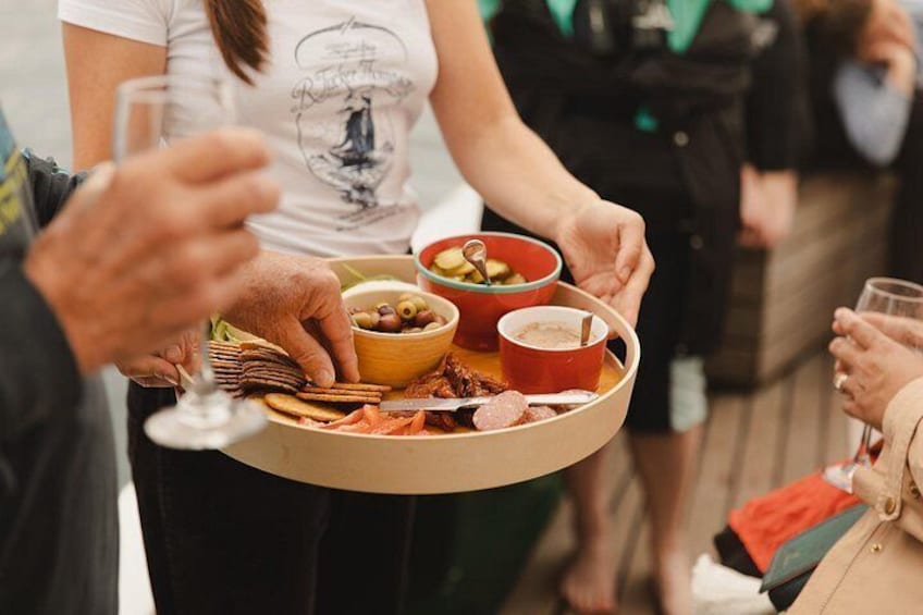 A person holding a tray with food and drinks. 4