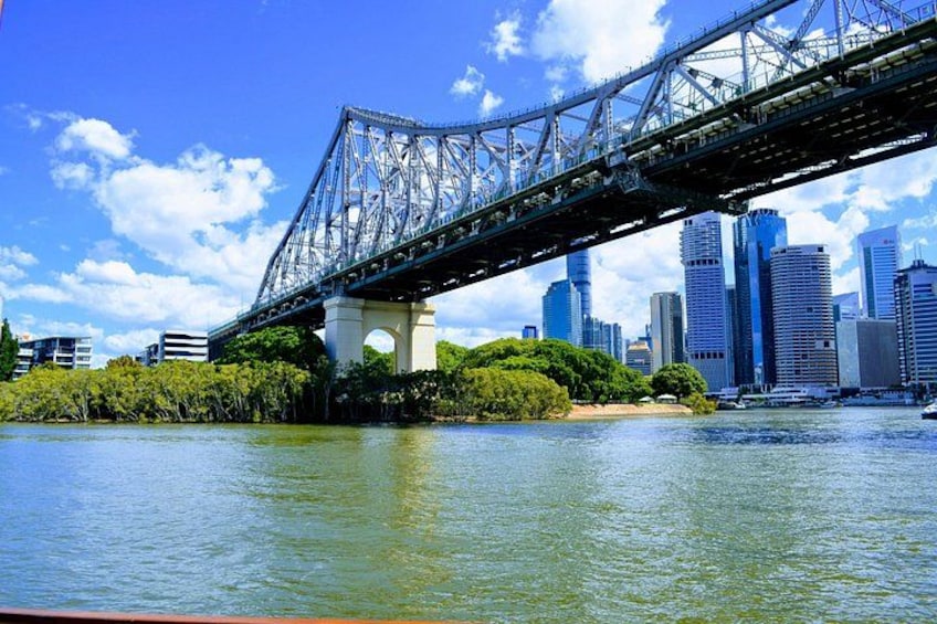 A bridge over water with a city skyline in the background. 2