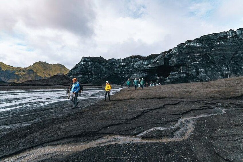 A glacier with people walking and biking. 2