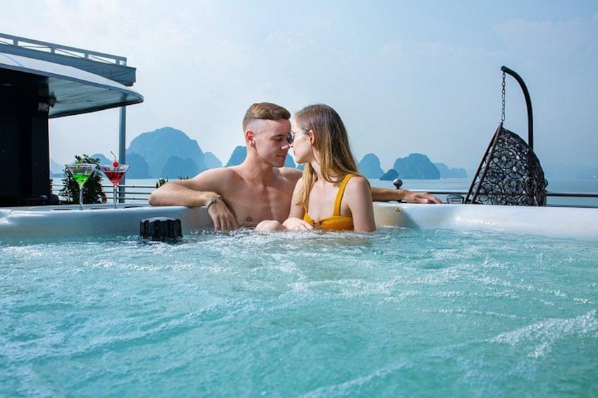 A couple in a hot tub with a tropical view. 4