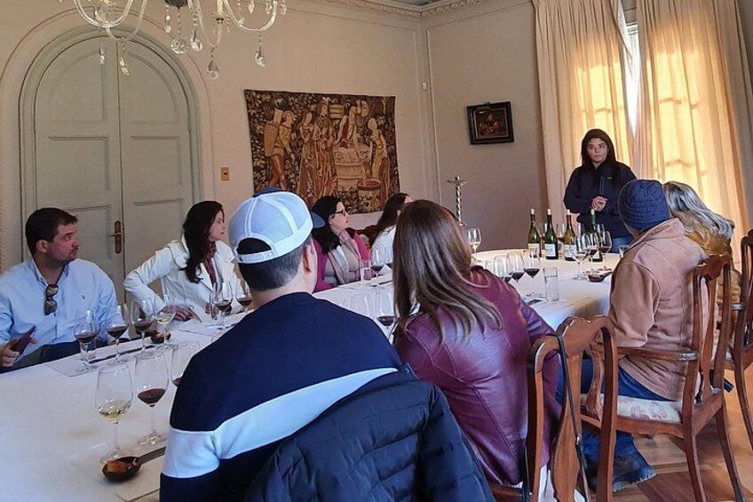 A group of people dining at a table with wine glasses and bottles. 5