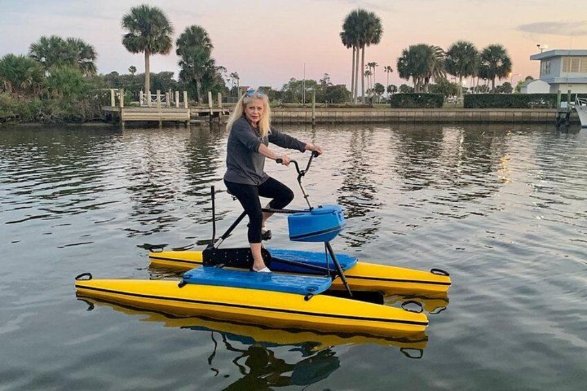 A person on a yellow raft with blue cushions, floating on calm water. 5