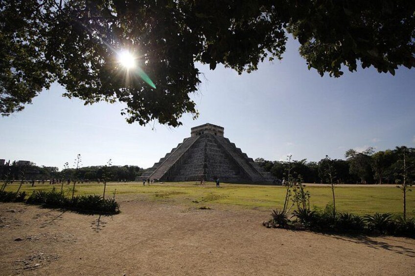 A large pyramid structure in a park with a clear sky and sunlight. 2