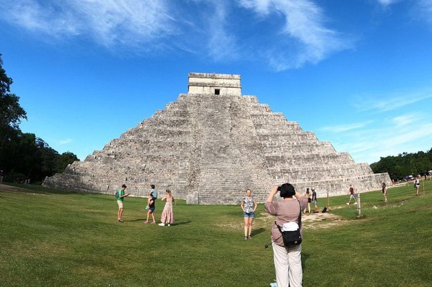 A large pyramid structure with people around it. 3