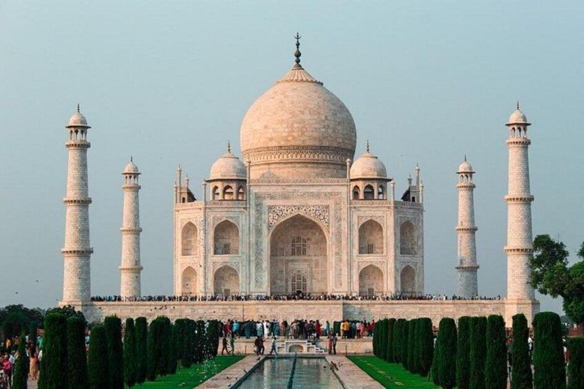 The Taj Mahal with four minarets, a large central dome, and a symmetrical facade. 3