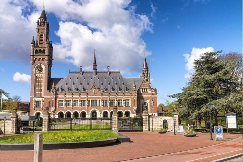 A historic building with a clock tower and multiple spires. 5