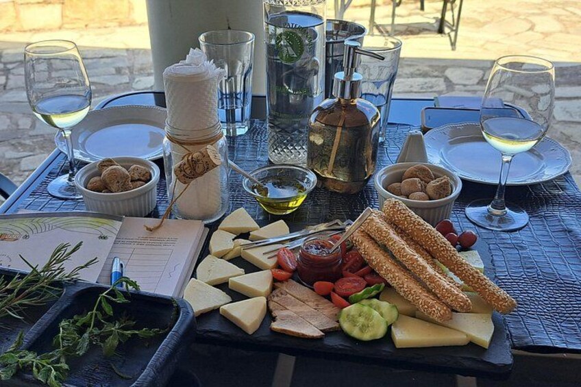 A table set for a meal with cheese, bread, and wine glasses. 3