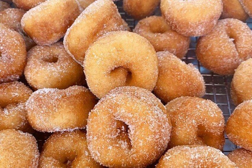 A pile of sugar-coated doughnuts. 3
