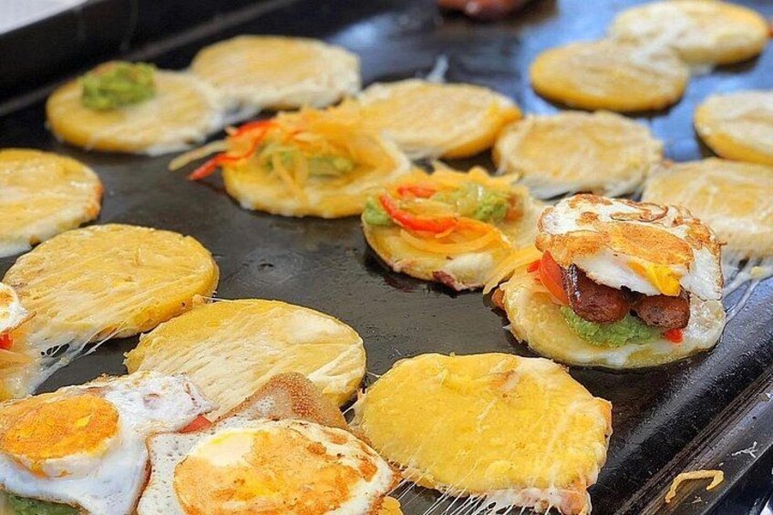 A cooking scene with food being grilled on a flat surface. 4