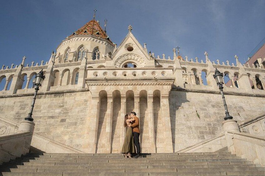 A grand building with a dome and ornate architecture, a staircase leading up to it, and a person standing at the bottom. 4