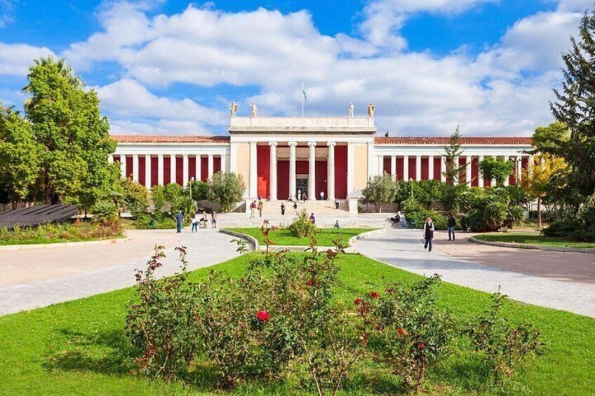 A classical building with columns, a central entrance, and a well-maintained garden. 3