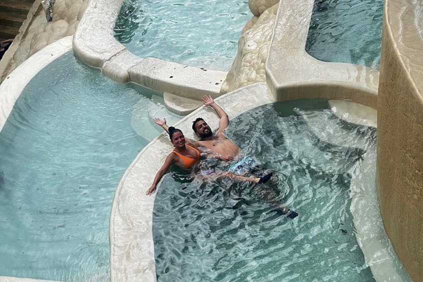 A hot tub with two people relaxing in it. 1