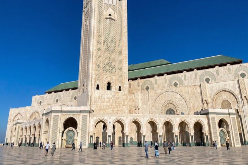 A large mosque with a tall minaret and multiple arches. 3