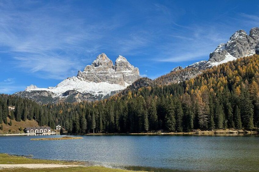 A mountain range with a lake in the foreground and a clear sky. 1