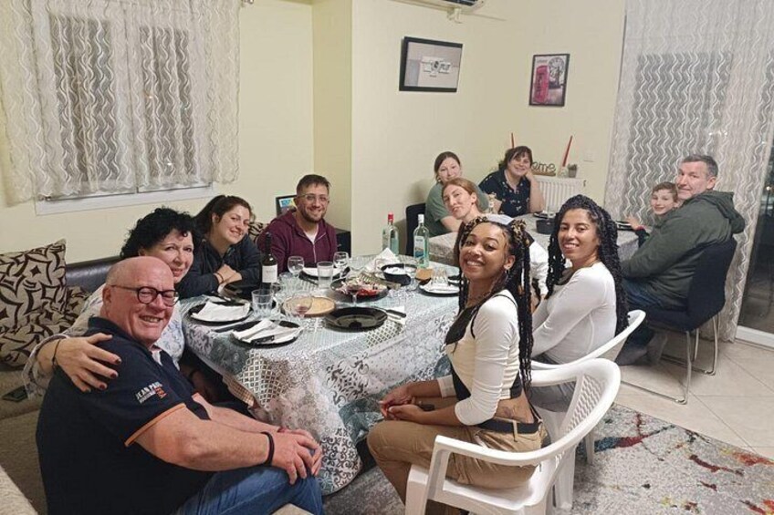 A family dining at a table with food and drinks. 5