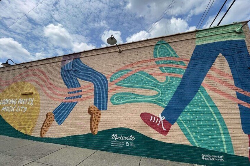 A mural with abstract figures and the text 'Working Pretty Music City.' 5