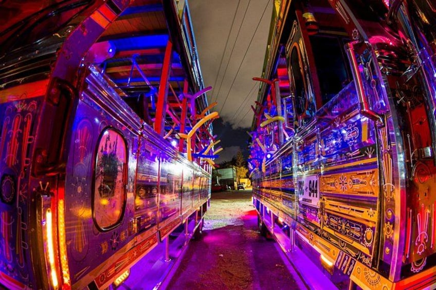 A brightly lit, colorful train with intricate designs and the number 944 visible. 3