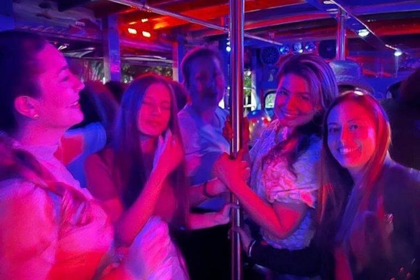 People in a dimly lit indoor setting with red and blue lighting. 4
