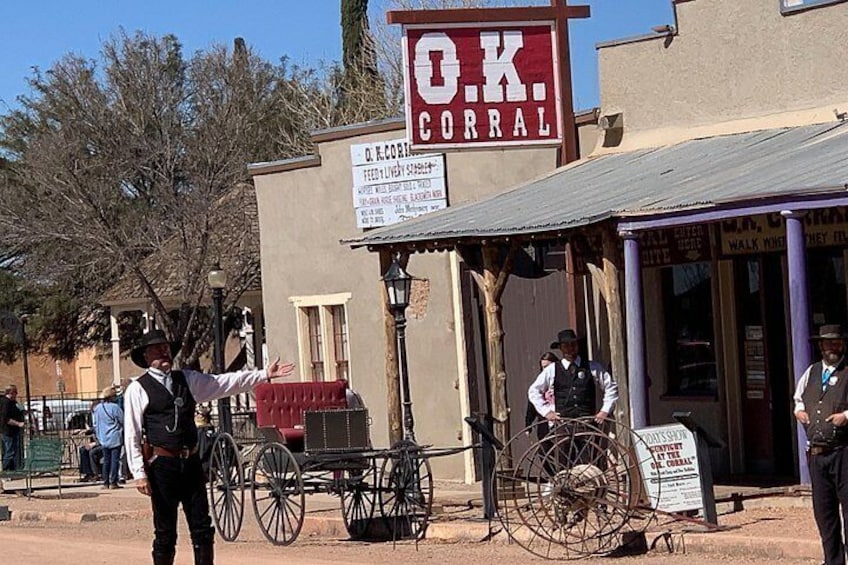 A Western-style saloon with a sign reading 'O.K. CORRAL' and a buggy parked outside. 5