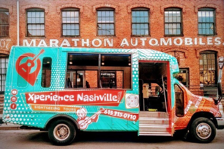 A colorful food truck parked in front of a brick building with the sign 'MARATHON AUTOMOBILES.' 5