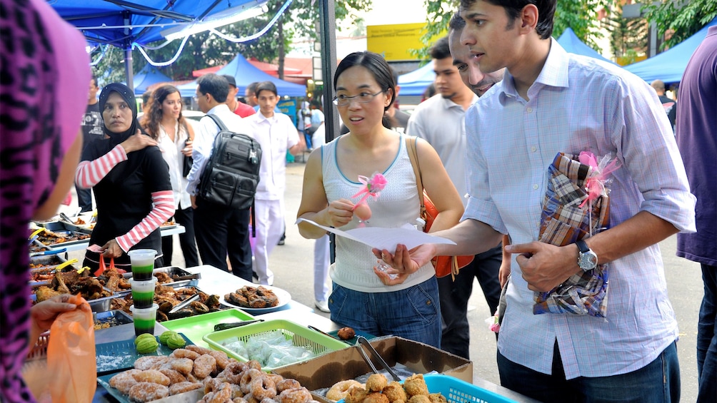 Couple at a food stall in Kuala Lumpur, Malaysia