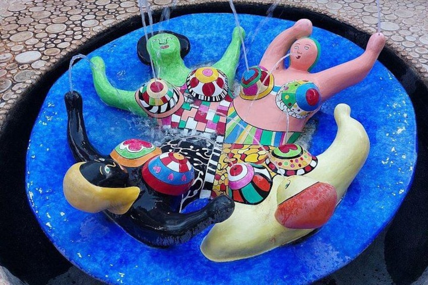 A colorful fountain with various animal figures. 3