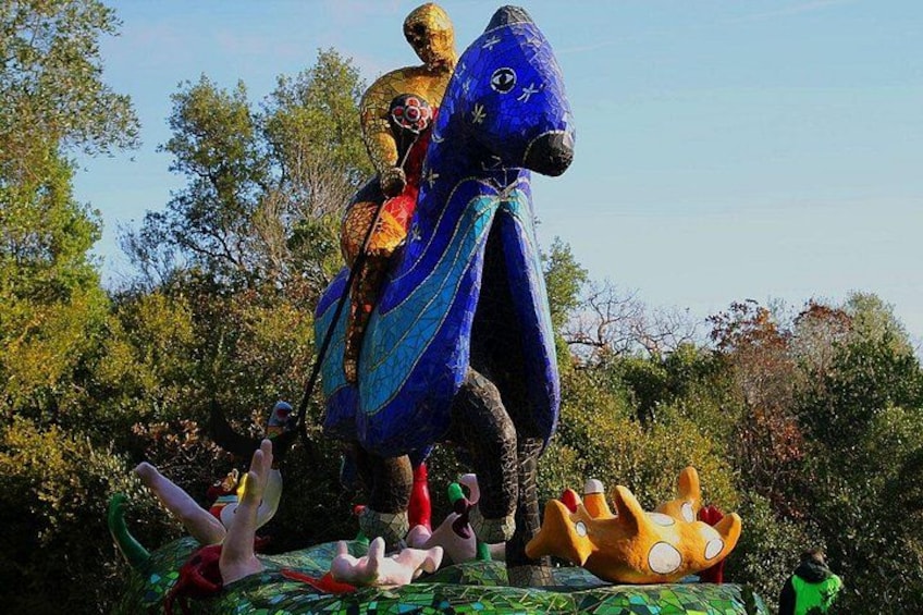 A large blue and gold statue of a mythical creature, possibly a dragon, with a rider. 5