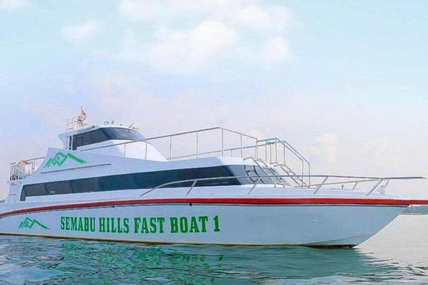 A white boat with 'SEMABU HILLS FAST BOAT 1' written on its side, a cabin, and a small bridge. 2