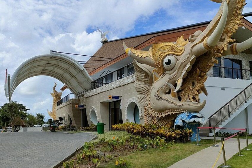A building with a large dragon sculpture in front. 4