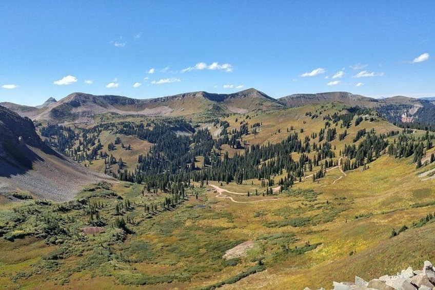 A mountainous landscape with dense forests and a clear sky. 5