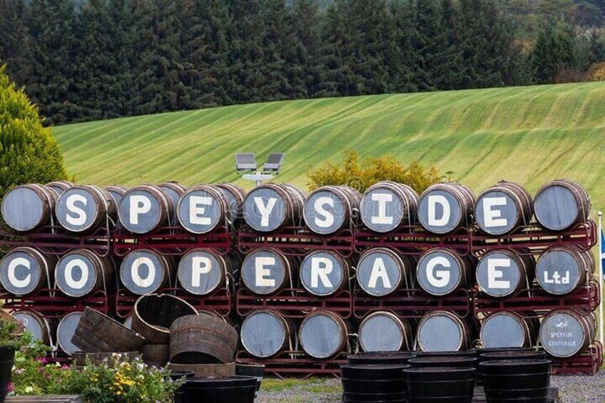 A sign with barrels stacked in rows, spelling out "SPEYSIDE COOPERAGE Ltd." in large letters. 2