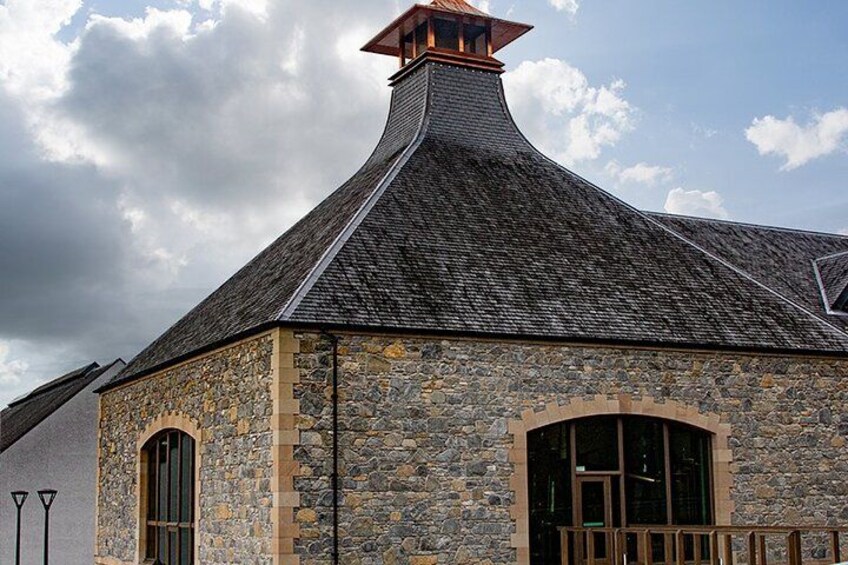A stone building with a steeply pitched roof and a chimney. 3
