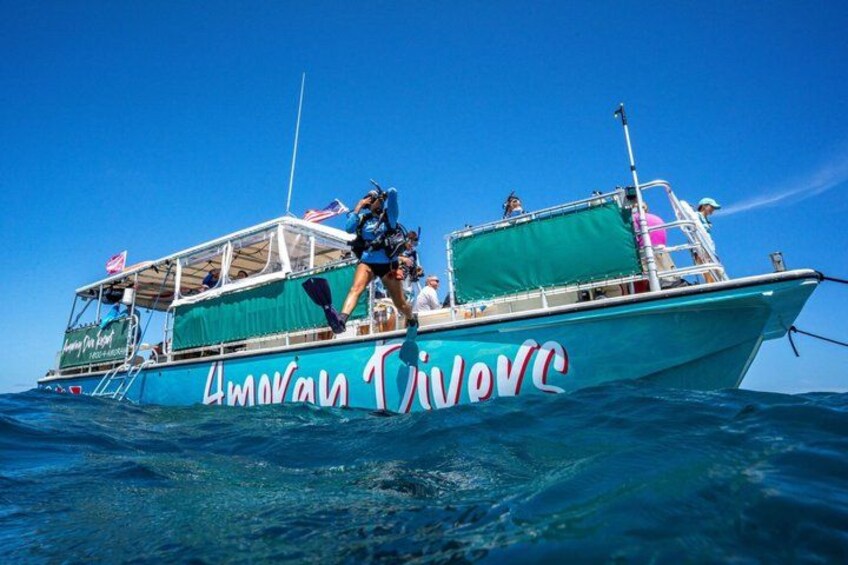 A boat named 'Amman Trivoca' with passengers and a lifebuoy on deck. 4