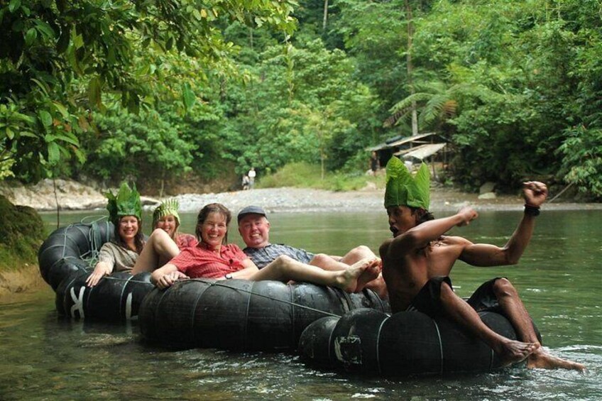 People floating on a river in an inflatable tube, surrounded by lush greenery. 2