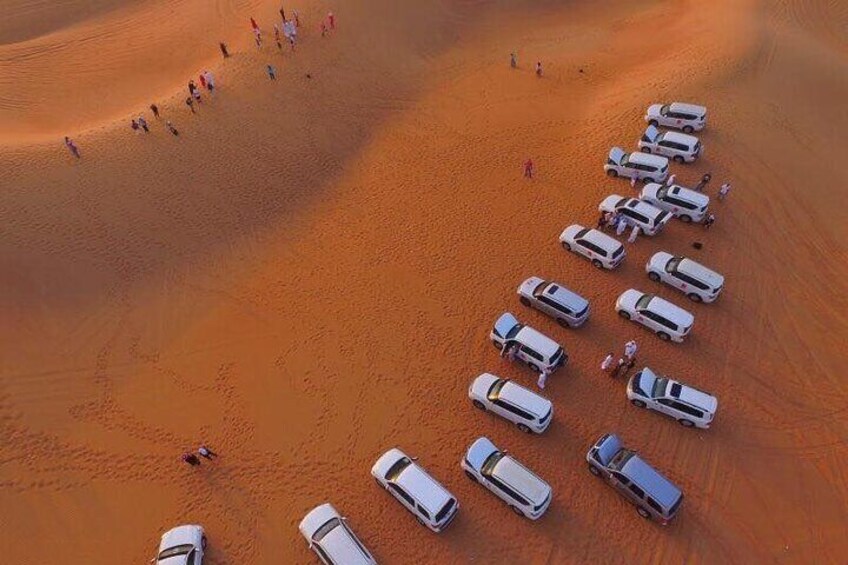 Arial view group of cars at picture stop in the desert