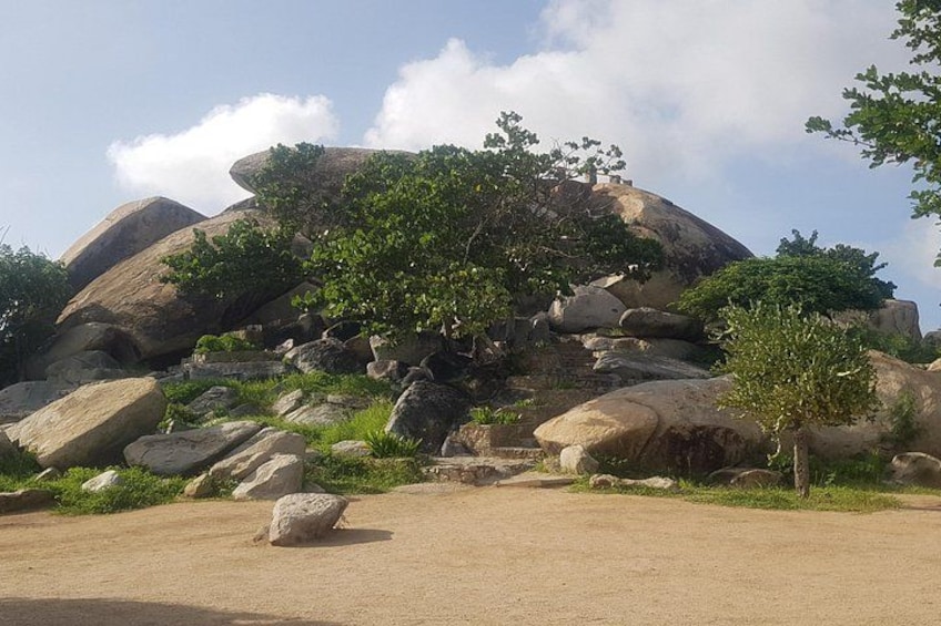 A rocky landscape with large boulders and sparse vegetation. 4