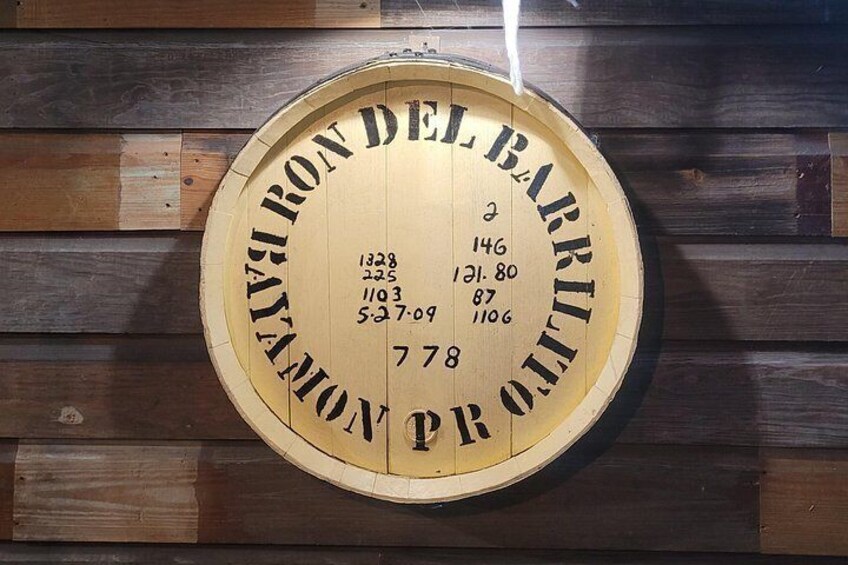 A wooden barrel with engraved text and numbers. 1