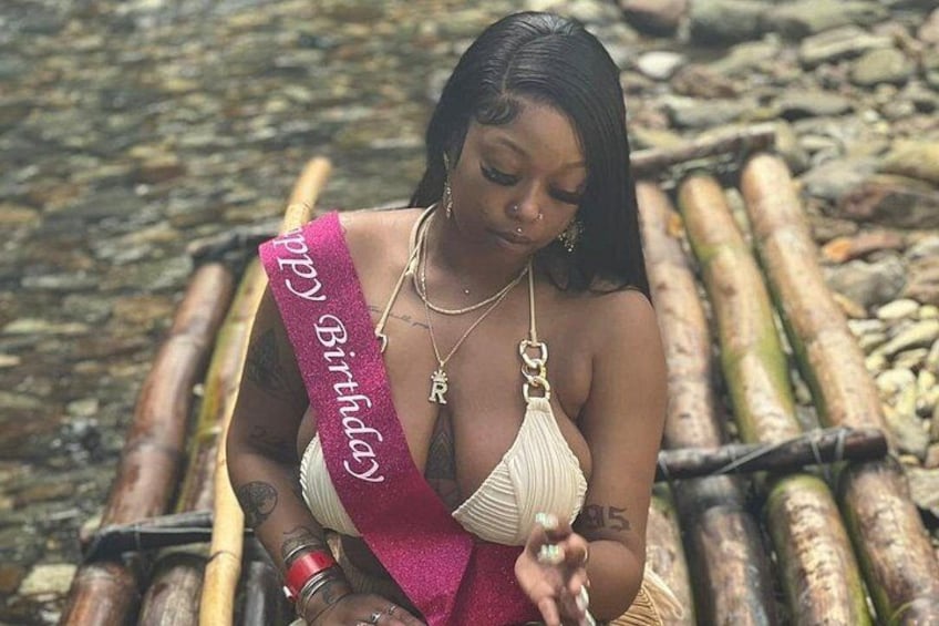 A person sitting on a wooden structure with a sash that reads 'Miss'. 3