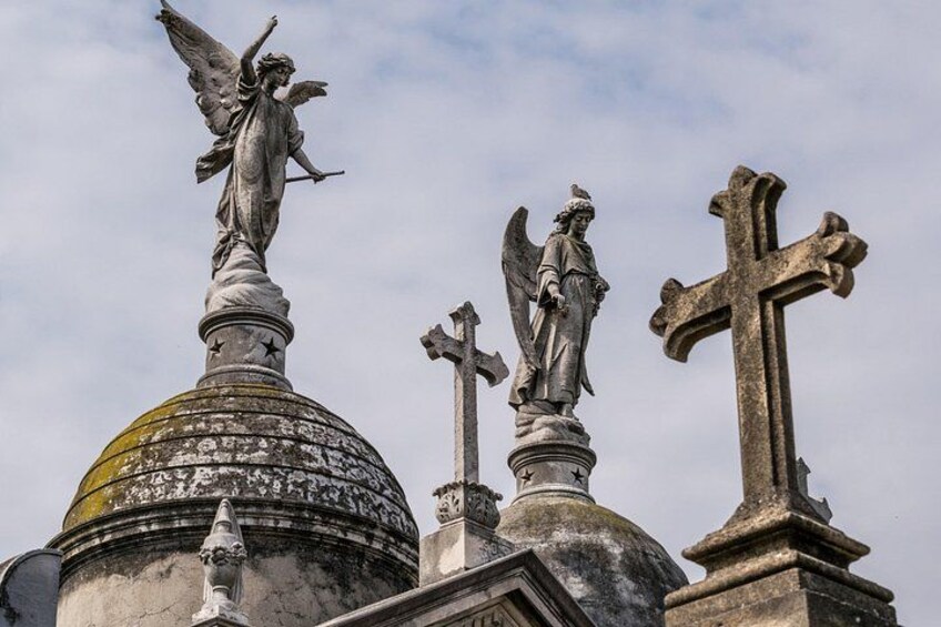 Een verweerde kerktoren met beelden van engelen en kruisbeelden. 4
