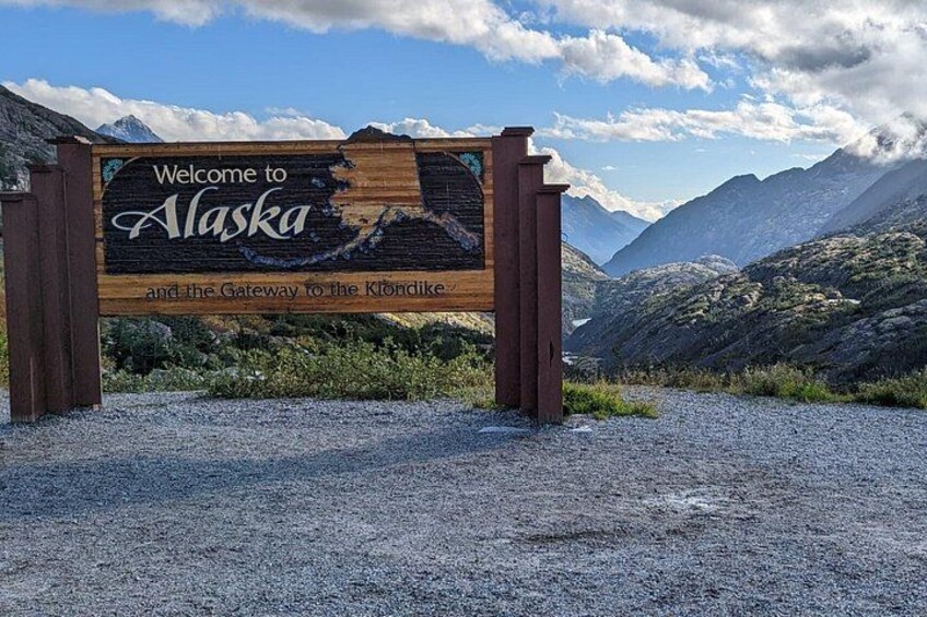 Stop at the Welcome to Alaska sign is included 2