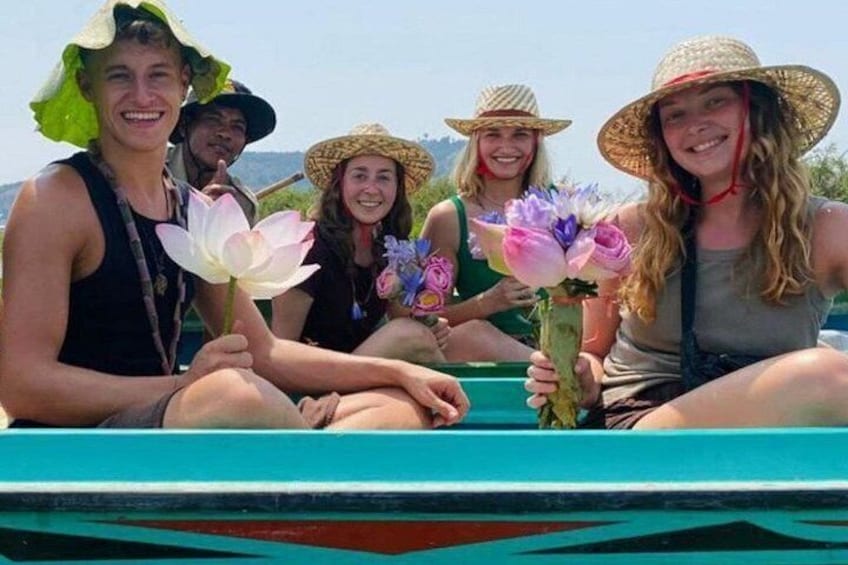 A group of people on a boat with flowers. 2