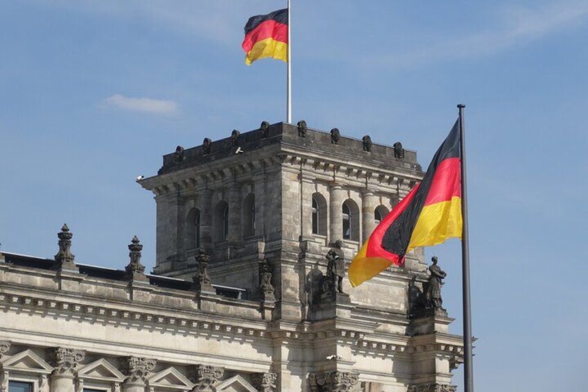A historic building with a flagpole and a flag. 4