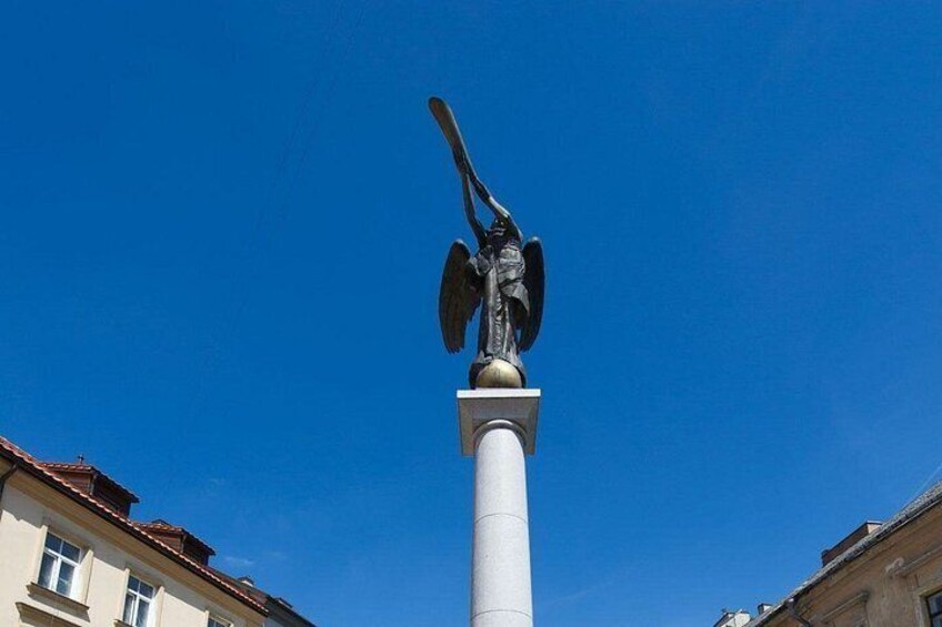 A tall column with a statue of a winged figure at the top. 5