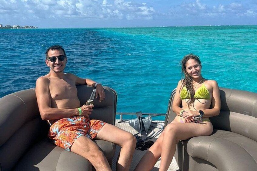 Two people on a boat in turquoise waters. 1