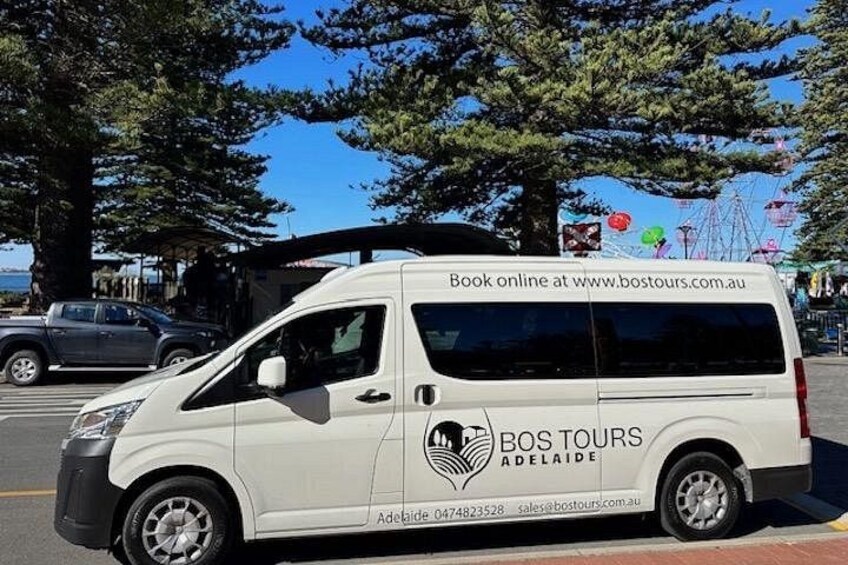 A white van with 'BOS TOURS ADELAIDE' and contact information on the side. 2