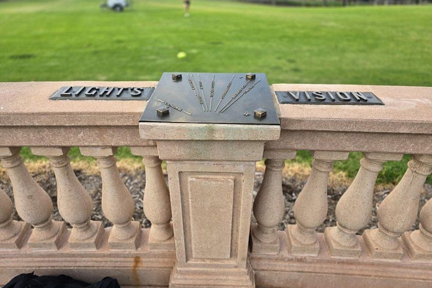 A stone balustrade with the words 'LIGHTS' and 'VISION' engraved on it. 5