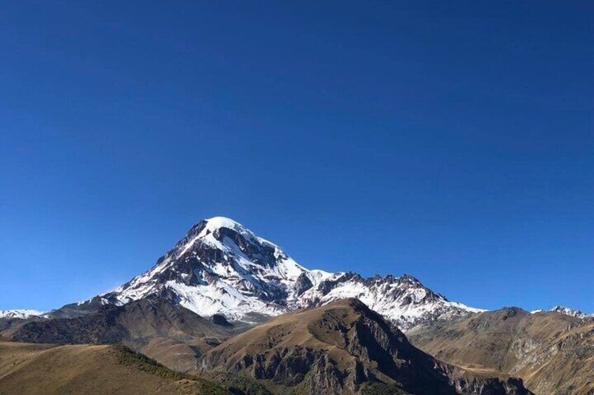 A snow-capped mountain with a clear blue sky. 4