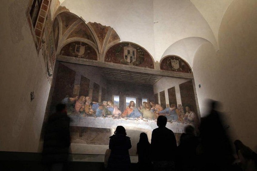 A famous painting with figures seated at a table, a high arched ceiling, and a viewer's shadow. 2