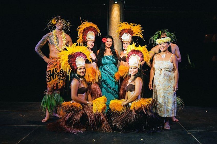 A group of people in colorful costumes and feathered headdresses. 2